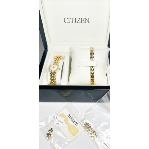 175 - A gold plated wristwatch by Citizen, with oval shaped face and white faceted stones set to the bezel... 