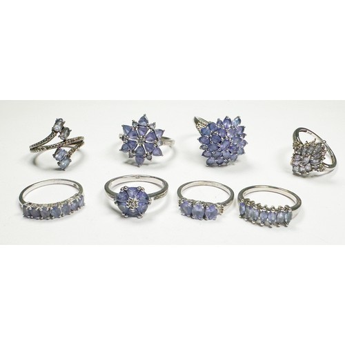 187 - Eight various silver dress rings, set with tanzanite, total weight 26.0 grams.