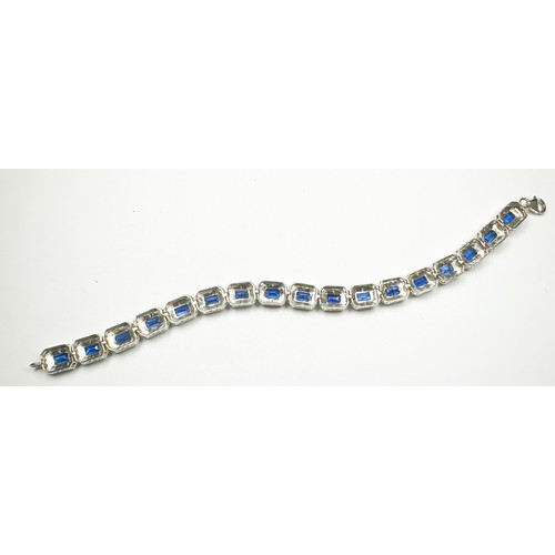 201 - A silver bracelet, set with 17 x rectangular shaped sapphires, each sapphire claw-set with small dia... 