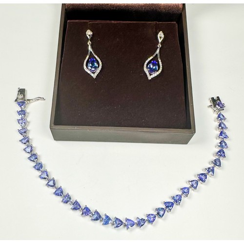 235 - A silver bracelet, claw set with 34 x trilliant-cut tanzanite gemstones, weighing approximately 11.0... 