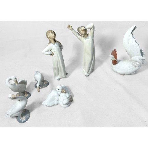 39 - A Lladro porcleian chicken, two children in nightclothes, three geese and a NAO duck group, (7)