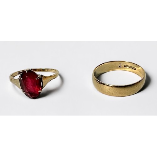 249 - Two 9ct gold rings, including a wedding band and one set with an oval faceted ruby coloured stone, g... 