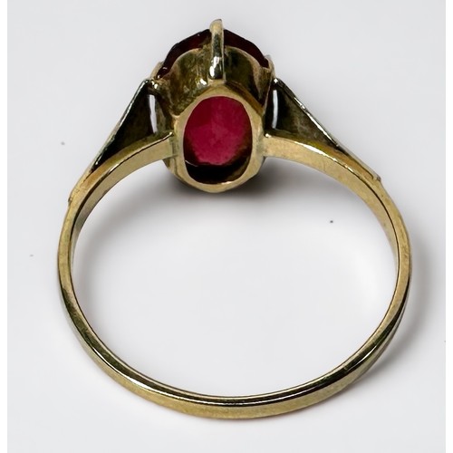 249 - Two 9ct gold rings, including a wedding band and one set with an oval faceted ruby coloured stone, g... 