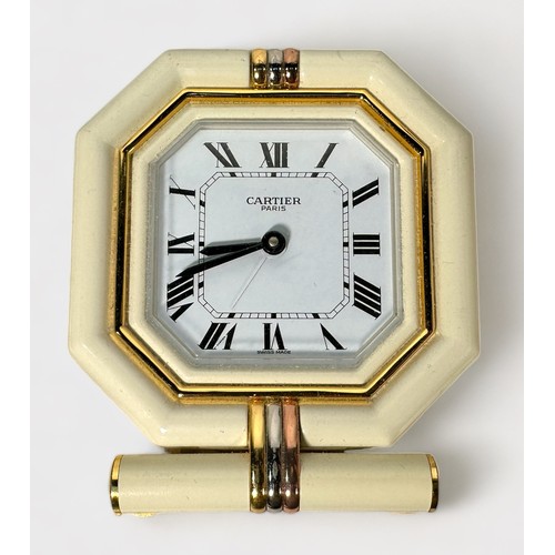 147 - A Cartier travel alarm clock, with Swiss Quartz movement, Octagonal case with white bezel and tri-co... 