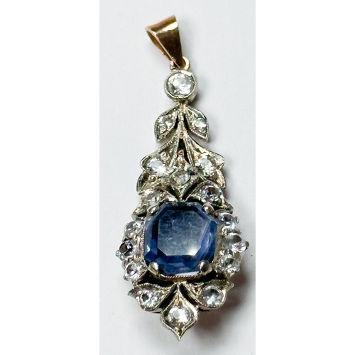 149 - A blue and white sapphire drop pendant, set with a cushion cut pale sapphire to the centre, with whi... 