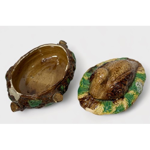 68 - A 19th century Majolica pottery game dish and cover modelled with a Quail, 15cm long, together with ... 