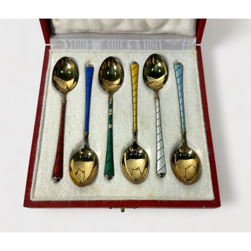 127 - A cased set of six Danish silver-gilt and guilloche enamel coffee spoons, decorated in various colou... 