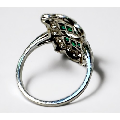 269 - An Art Deco period platinum ring, the shaped top centrally set with a marquise cut diamond surrounde... 