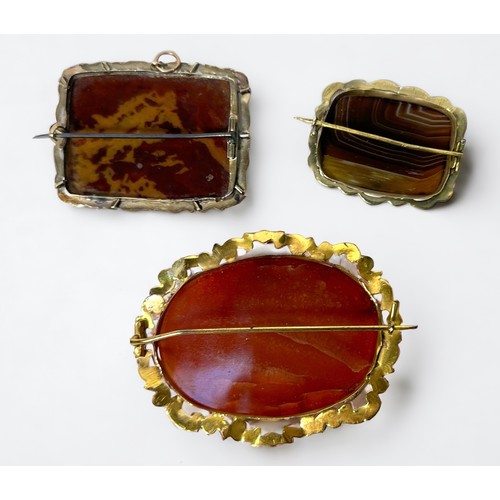 265 - A yellow metal, tests as 14ct gold or above brooch, set with a rectangular hardstone, together with ... 