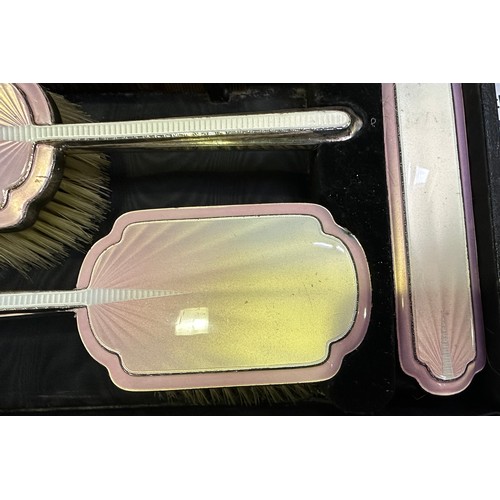 103 - A six-piece silver and pink guilloche enamel dressing table set by Albert Carter, comprising four br... 