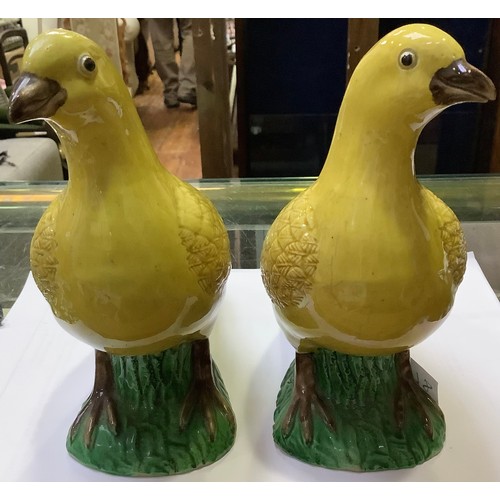 81 - A pair of Chinese Porcelain birds, decorated in Wucai colours with yellow, green and brown glazes, 1... 