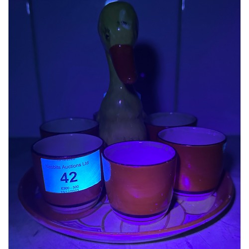 42 - A Clarice Cliff Bizarre ‘Mr Puddleduck’ novelty egg cup cruet set for six, circa 1930, in the ‘Melon... 