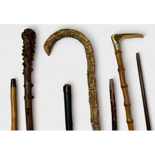 450 - Seven various vintage walking sticks, comprising, two golf Sunday walking sticks, a wooden example w... 