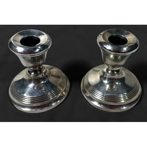 118 - A pair of silver candlesticks of inverted baluster form, with detachable drip pans, Birmingham, 1965... 