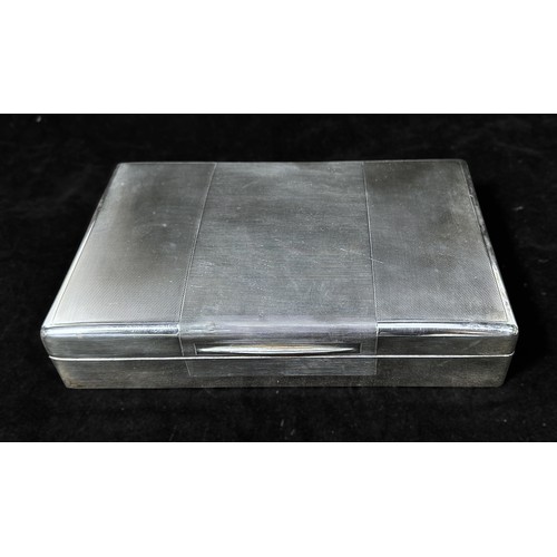 122 - A George VI Silver table-top cigarette box, of rectangular form with engine-turned hinged cover encl... 