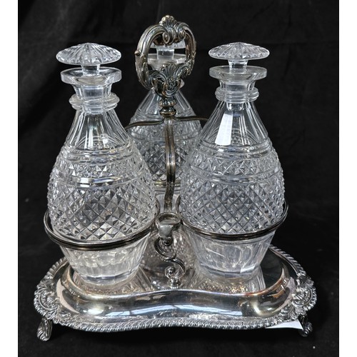 120 - A Victorian silver-plated three-bottle decanter stand, with three original hobnail and panel-cut gla... 