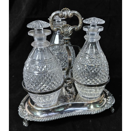 120 - A Victorian silver-plated three-bottle decanter stand, with three original hobnail and panel-cut gla... 