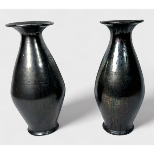 22 - A pair of glazed brown iridescent vases, of tapering ovoid form, with wide flanged neck, metallic fi... 