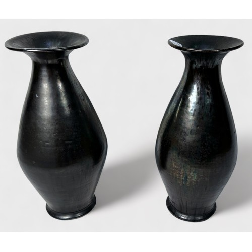 22 - A pair of glazed brown iridescent vases, of tapering ovoid form, with wide flanged neck, metallic fi... 