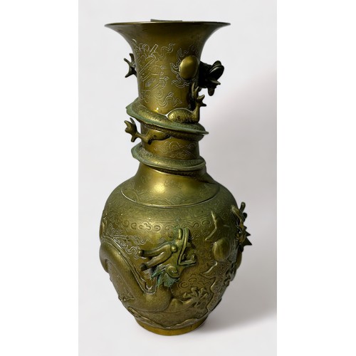 82 - A Chinese brass vase of globular form, decorated with applied four-clawed dragons and high relief dr... 