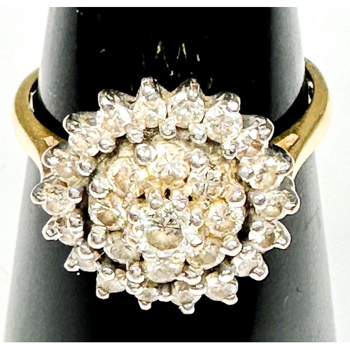 200 - An 18ct yellow gold dress ring, claw set with round brilliant cut diamonds, in a cluster design, est... 