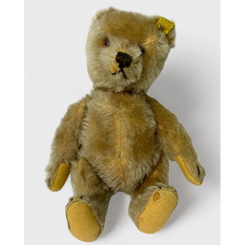 529 - A 20th Century jointed blonde mohair Steiff teddy bear, with yellow tag and button in ear, felt pads... 