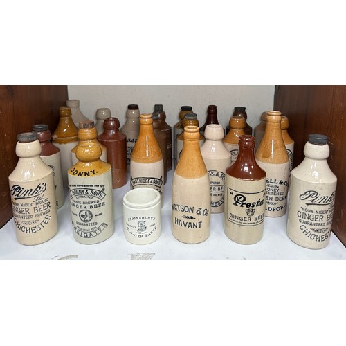 23 - Twenty-four various stoneware ginger beer bottles, including local interest examples, six Pink’s ‘Pi... 