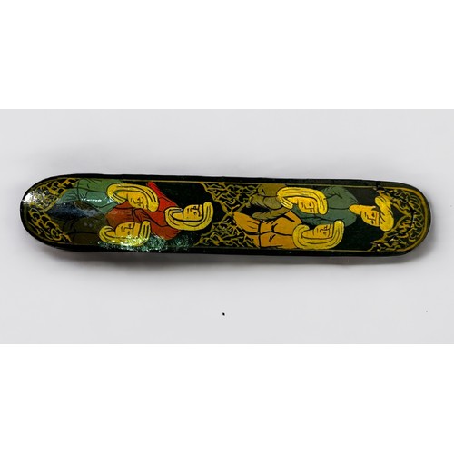 471 - An antique papier maché lacquered qalamdan (pen box) with sliding implement tray, painted with figur... 