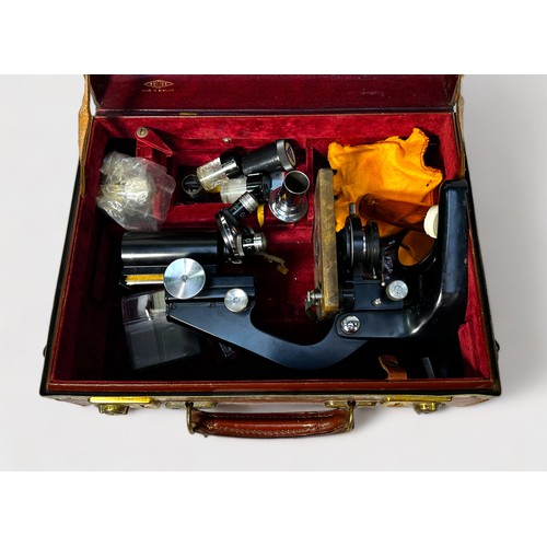 469 - A Watson Barnet monocular microscope, numbered 128587, in brown leather carry case with various flui... 