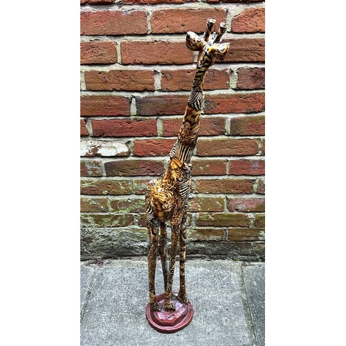 476 - A model of a giraffe by ‘Collage’, with printed safari decoration, raised on naturalistic base, 101c... 