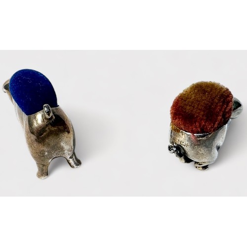 356 - Two various sterling silver pin cushions modelled as pigs, the smaller example with rubbed Birmigham... 