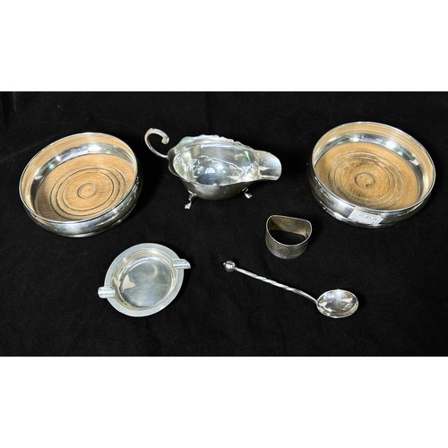 137 - A pair of silver bottle coasters with turned wooden bases, together with an Arts & Crafts spoon with... 