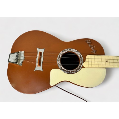 543 - A vintage Elvis Presley toy guitar by Selcol, the brown, cream and burgundy plastic four string guit... 