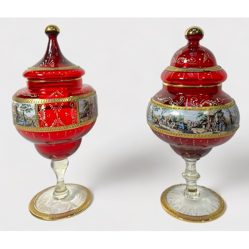 54 - Two Czech Bohemian ruby glass vases and covers, each with central bands of printed and painted scene... 