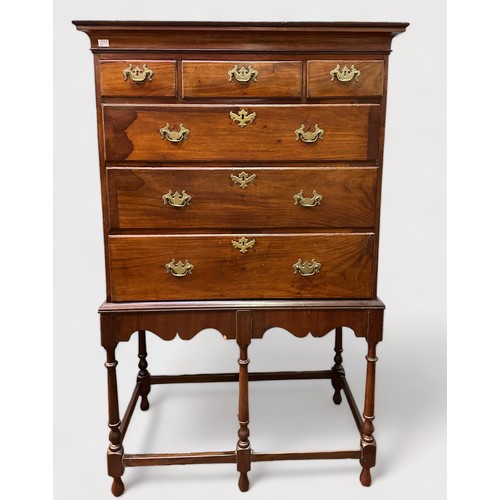 699 - A George III mahogany chest on associated later stand, of three short and three long graduated drawe... 