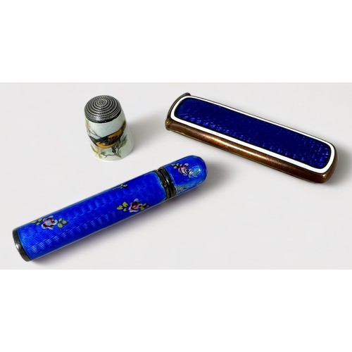 386 - A blue guilloche enamel and floral painted white-metal needle case of cylindrical form with screw ca... 