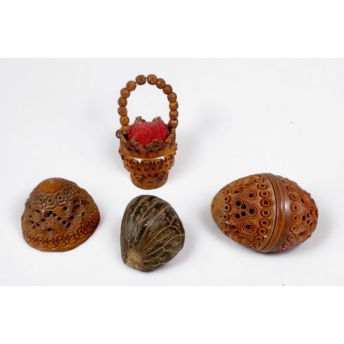 377 - A carved and pierced Coquilla nut bucket pin cushion, a carved and pierced coquilla nut pomander, ha... 