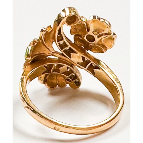 223 - An 18ct yellow gold dress ring in a foliate style, set with small diamonds in pink and green enamell... 