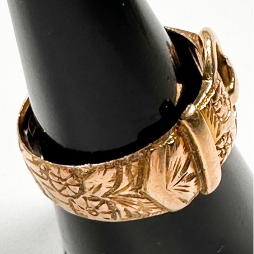 224 - An 18ct yellow gold buckle ring with foliate engraving, ring weighs 8.6 grams, hallmarked 1910.