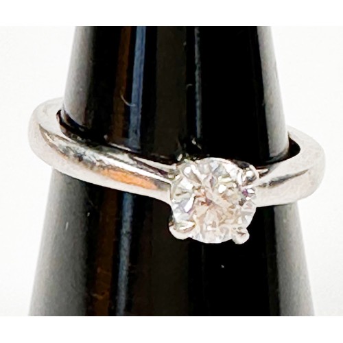 241 - A solitaire diamond ring, four-claw set in a raised Tiffany-style platinum band, with knife edge sho... 