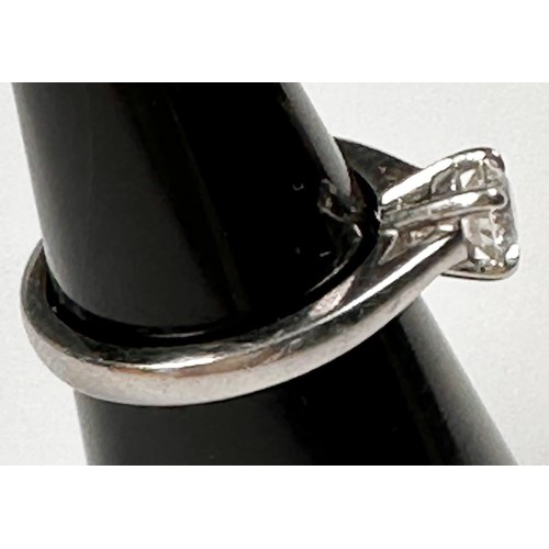 241 - A solitaire diamond ring, four-claw set in a raised Tiffany-style platinum band, with knife edge sho... 