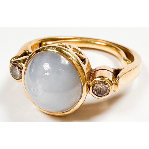 193K - An 18ct yellow gold dress ring, set with a round shaped grey star sapphire, bezel set with a round d... 