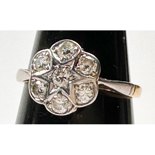 193C - An 18ct yellow gold cluster ring, set with seven round diamonds in a white gold star and daisy desig... 