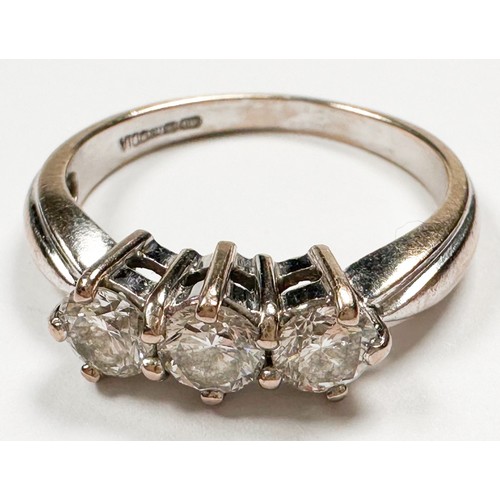 235 - An 18ct white gold ring, claw set with three round brilliant cut diamonds in an open-backed gallery,... 