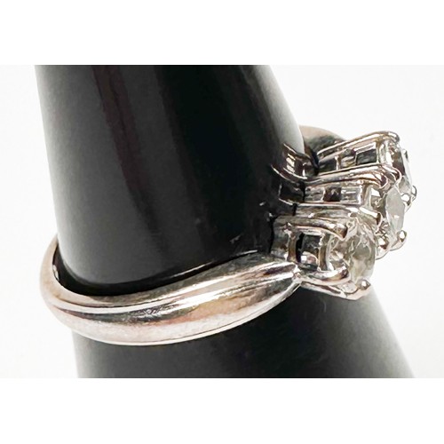 235 - An 18ct white gold ring, claw set with three round brilliant cut diamonds in an open-backed gallery,... 