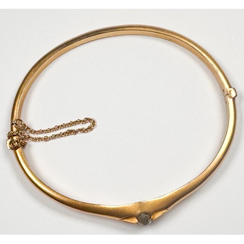 236 - A 9ct yellow gold hinged bangle, eight-claw set with a round-shaped old cut diamond to the centre, i... 