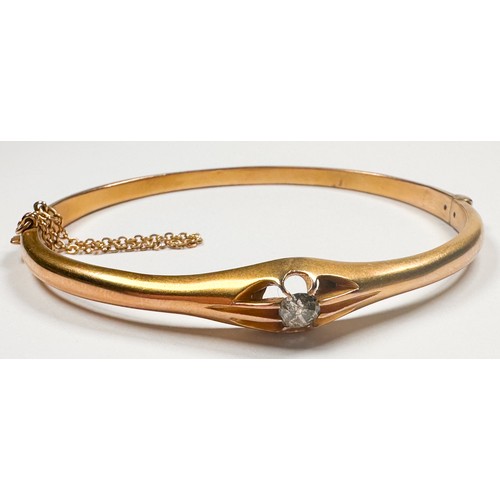 236 - A 9ct yellow gold hinged bangle, eight-claw set with a round-shaped old cut diamond to the centre, i... 