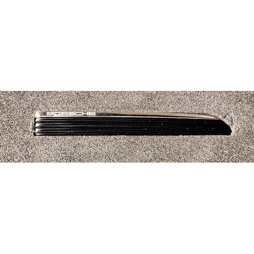 263 - A Porsche design clutch tie-pin, with discreet Porsche logo, made of black anodised aluminium and st... 