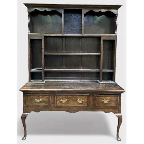 703 - An 18th century and later oak dresser, the later raised back section with shaped cornice, above shel... 