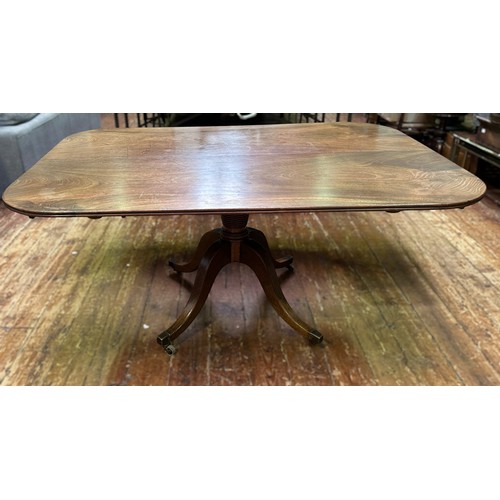 704 - A Regency mahogany shaped-rectangular tilt-top table, on ring turned tapering stem, quadripartite ba... 